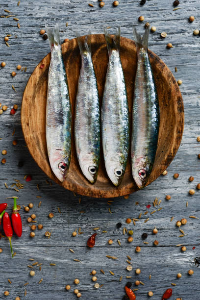 istock raw sardines on a rustic wooden table 1034235750