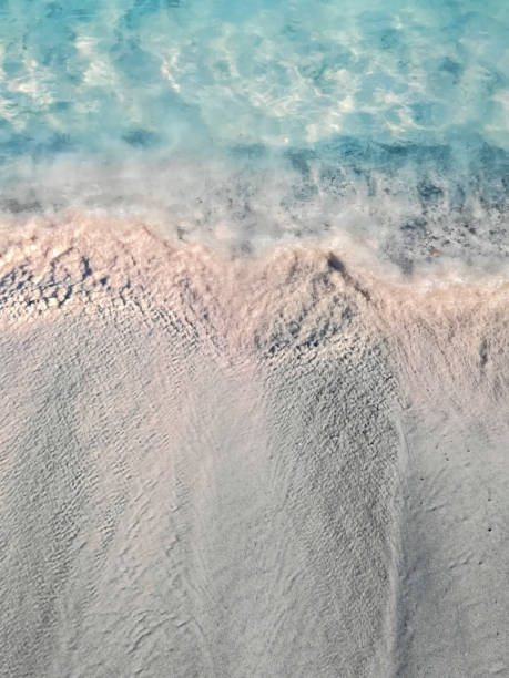 istock calm wave on a pink sandy beach in crete, greece 1034236154