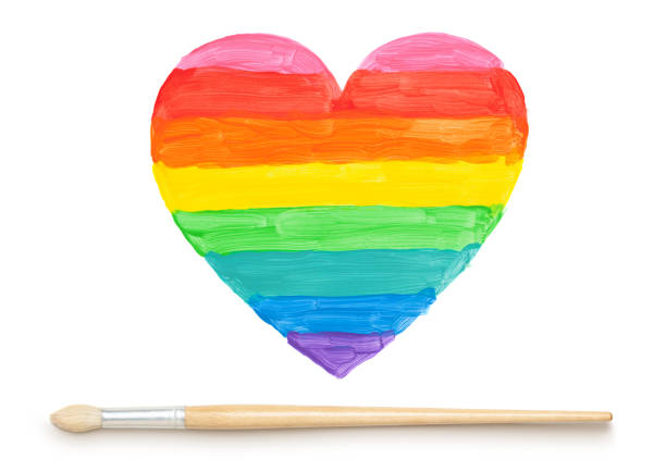 Painted colorful heart and paintbrush on white. This file is cleaned and retouched.