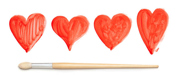 istock Painted red hearts and paintbrush on white 1034236470