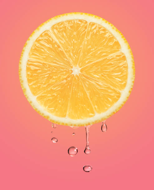 Perfect orange lemon slice and water drop on pink. This file is cleaned and retouched.