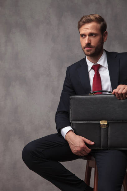 istock young businessman looks to side while waiting for interview 1034239288