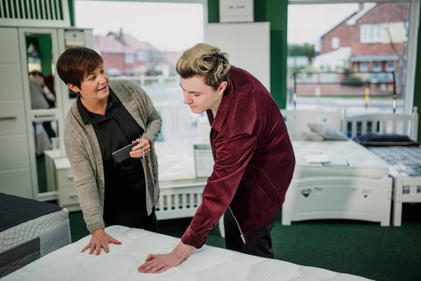 Young Man Shopping for a New Mattress