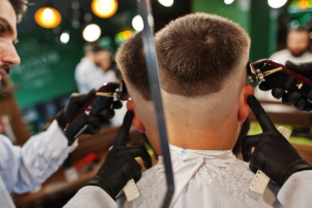 istock Handsome bearded man at the barbershop, barber at work. 1034239926