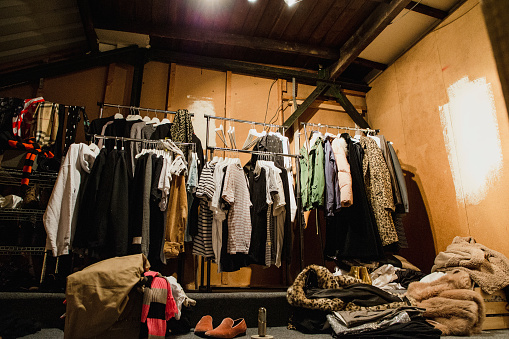 Pop-up dressing room with clothes on rails.