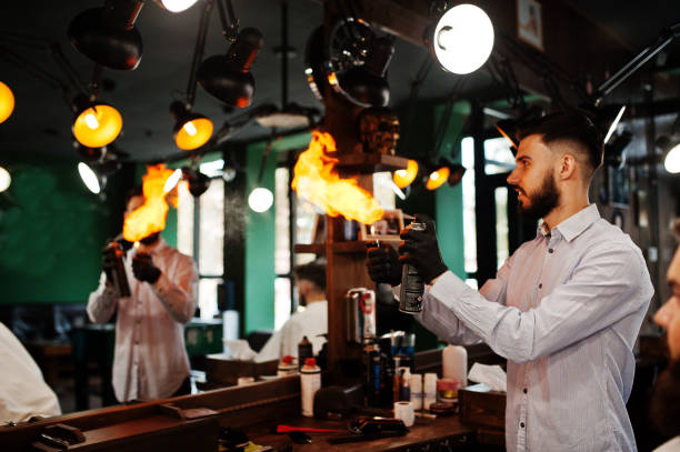istock Handsome bearded man at the barbershop, barber at work. 1034244918