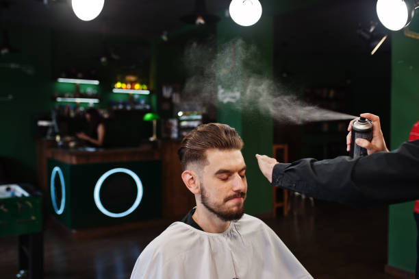 istock Handsome bearded man at the barbershop, barber at work. 1034245170