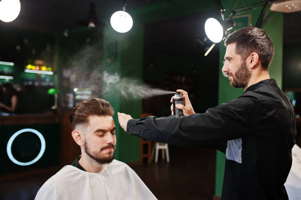 istock Handsome bearded man at the barbershop, barber at work. 1034245186
