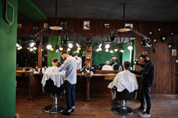 istock Handsome bearded man at the barbershop, barber at work. 1034245232