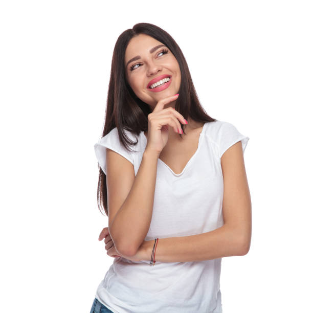istock smiling casual woman looking up to side while thinking 1034249542