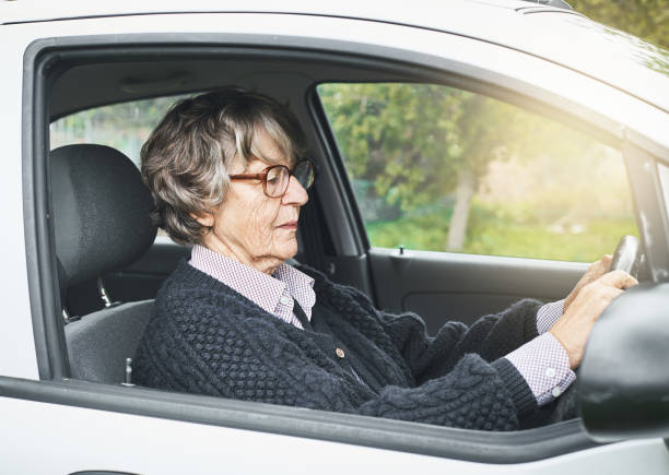 istock Confident senior woman driving her car 1034253540