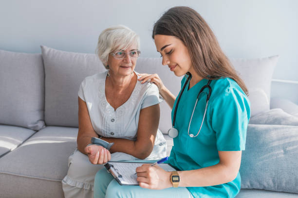 istock Doctor checking elderly woman's blood pressure 1034253952