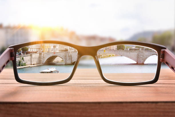 istock Concept of eyesight correction with glasses on a bridge handrails 1034257150