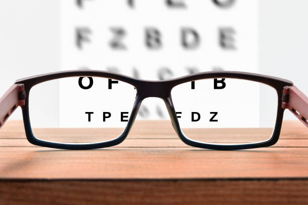 istock Glasses on table and alphabet letter front view 1034257266