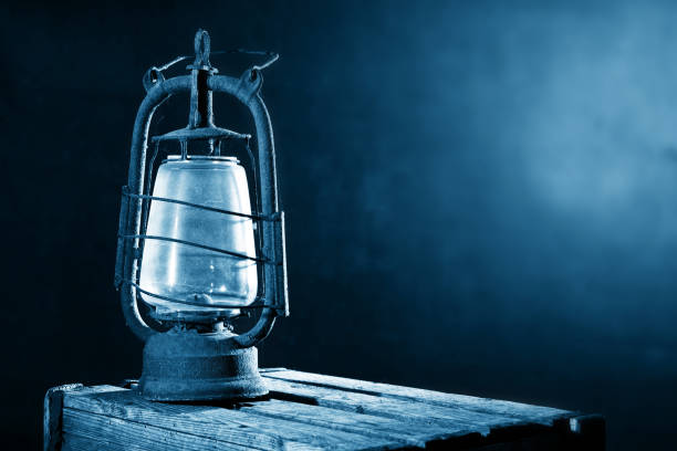 istock Old Rusty Lantern on the Wooden Desk in the Attic 1034260532