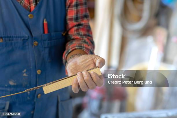 Man Measuring A Piece Of Wood Stock Photo - Download Image Now - Adult, Adults Only, Art and Craft Equipment