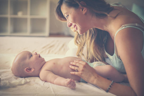 istock Young mother playing with her baby boy in bed. 1034265180