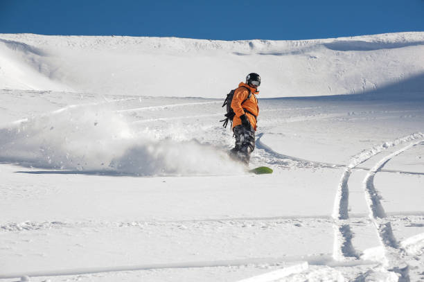 istock Freeride snowboarder sliding on the mountain slope 1034268822
