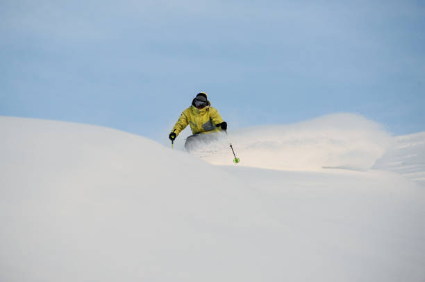 istock Professional snowboarder sliding down the snowy slope 1034270072