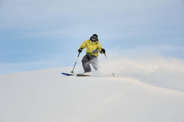 istock Professional snowboarder sliding down the mountain slope 1034270096
