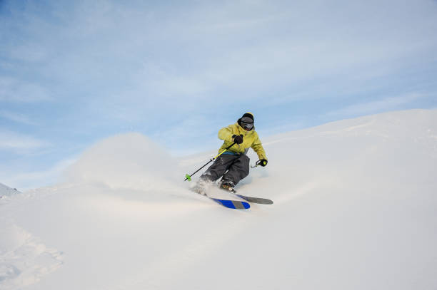 istock Professional snowboarder sliding down the snowy hill 1034270164