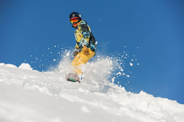 istock Bottom view of freeride snowboarder sliding down the slope 1034274966