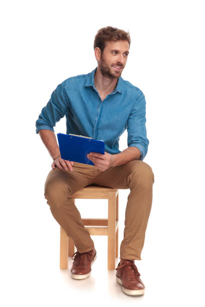 istock side view of a seated student with clipboard looking away 1034275034