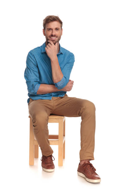 istock smiling seated casual man is thinking 1034275108