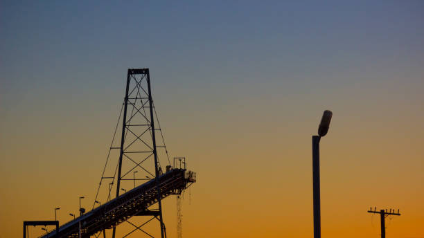 istock Conveyor belt carrying ore at a mine site processing plant. 1034275544