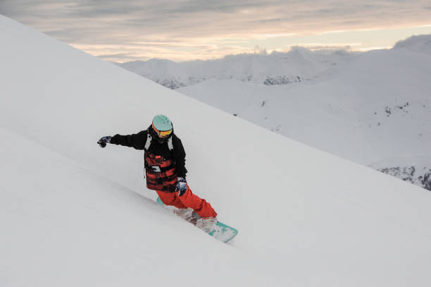 istock Freeride snowboarder sliding down the snowy slope 1034275778