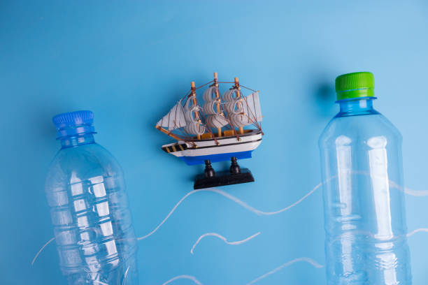 istock ocean Pollution concept. plastic bottles on blue background 1034275840