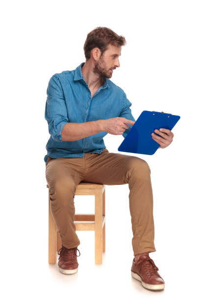 istock seated young student showing his notes to someone 1034276124
