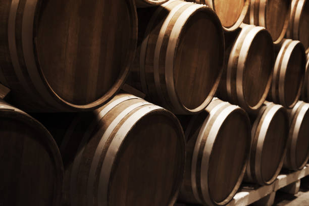 istock Round wooden barrels in dark winery 1034276208
