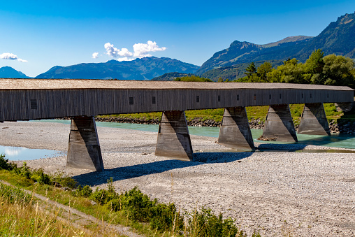 The old wooden bridge across the river Rhine on the border of Liechtenstein and Switzerland