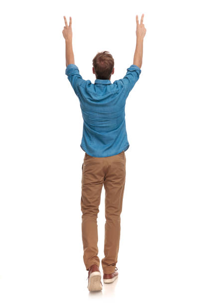 istock back of a man walking and celebrating victory 1034282924