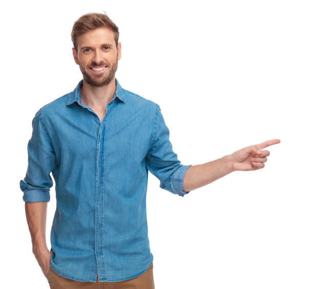 istock smiling young man is pointing to side 1034283136