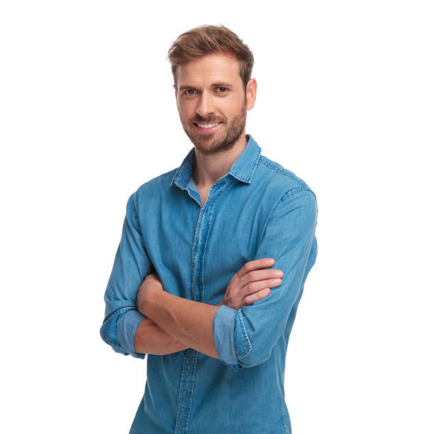 istock young smiling casual man standing with hands crossed 1034283178