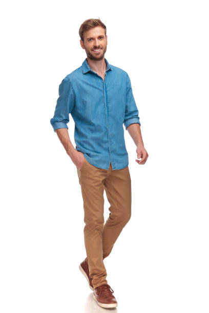 istock happy young casual man walking with hand in pocket 1034283294