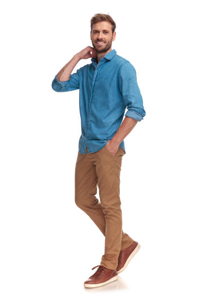 istock young casual man walking and fixing his collar 1034283346