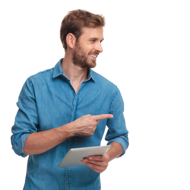istock casual man with tablet recommends something to side 1034283748