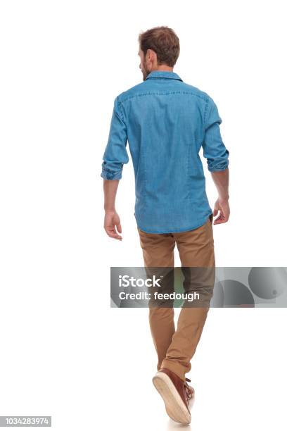 Back View Of Casual Man Walking And Looking To Side Stock Photo - Download Image Now