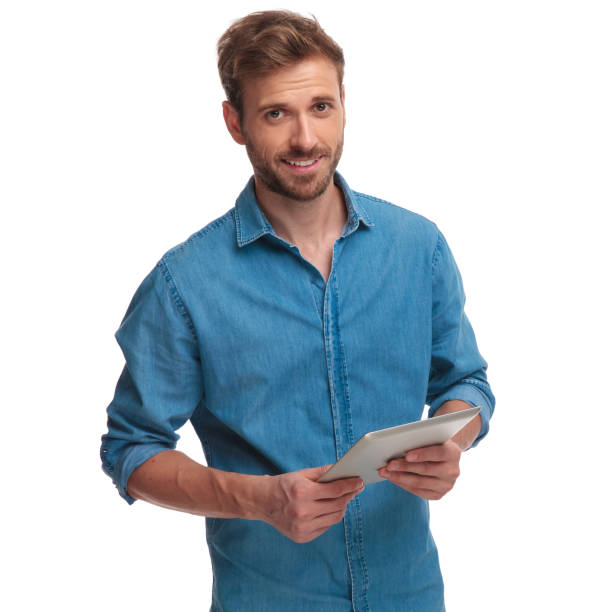 istock happy casual man holding ebook smiles 1034284150