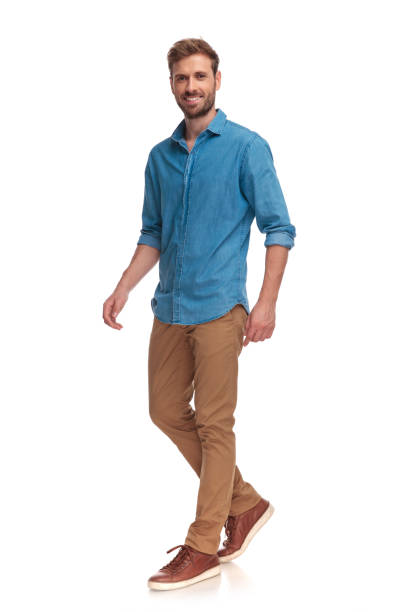 istock side view of a laughing young casual man walking 1034284586