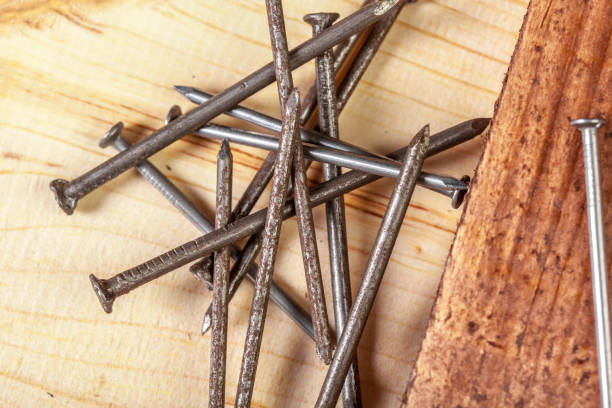 istock iron nails on a wooden table 1034285848