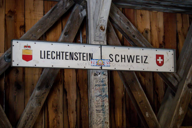 The international border post on the old wooden brdge across the river Rhine between Liechtenstein and Swizterland