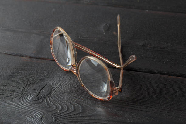 istock eyeglasses on wooden table 1034287320
