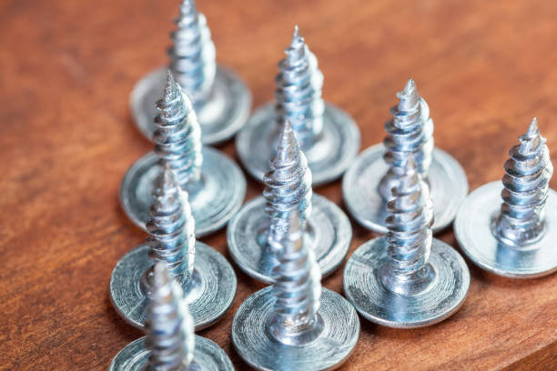 istock screws on a wooden table 1034289160