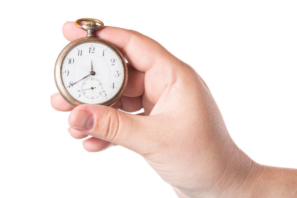 istock Female hand holding vintage clock isolated on a white background 1034293778
