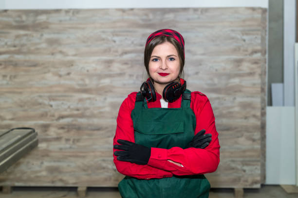 istock Beautiful smiling woodworker posing with crossed hands 1034295210