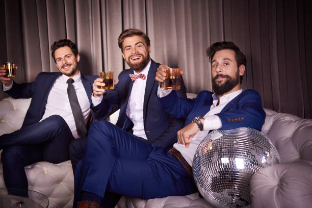 Portrait of elegant men with whiskey at night club Portrait of elegant men with whiskey at night club bourbon whiskey photos stock pictures, royalty-free photos & images